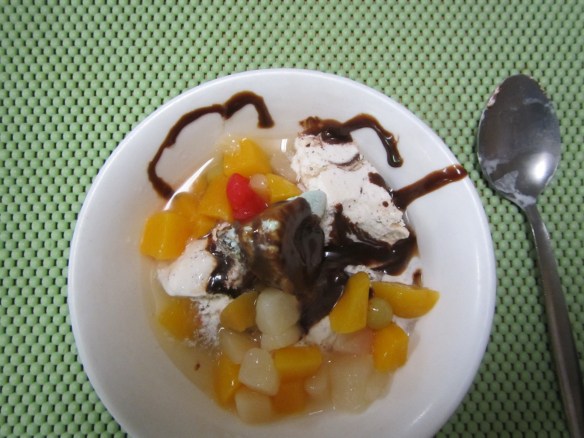 Ís og ávextir með heitri súkkulaðisósu í eftirrétt.